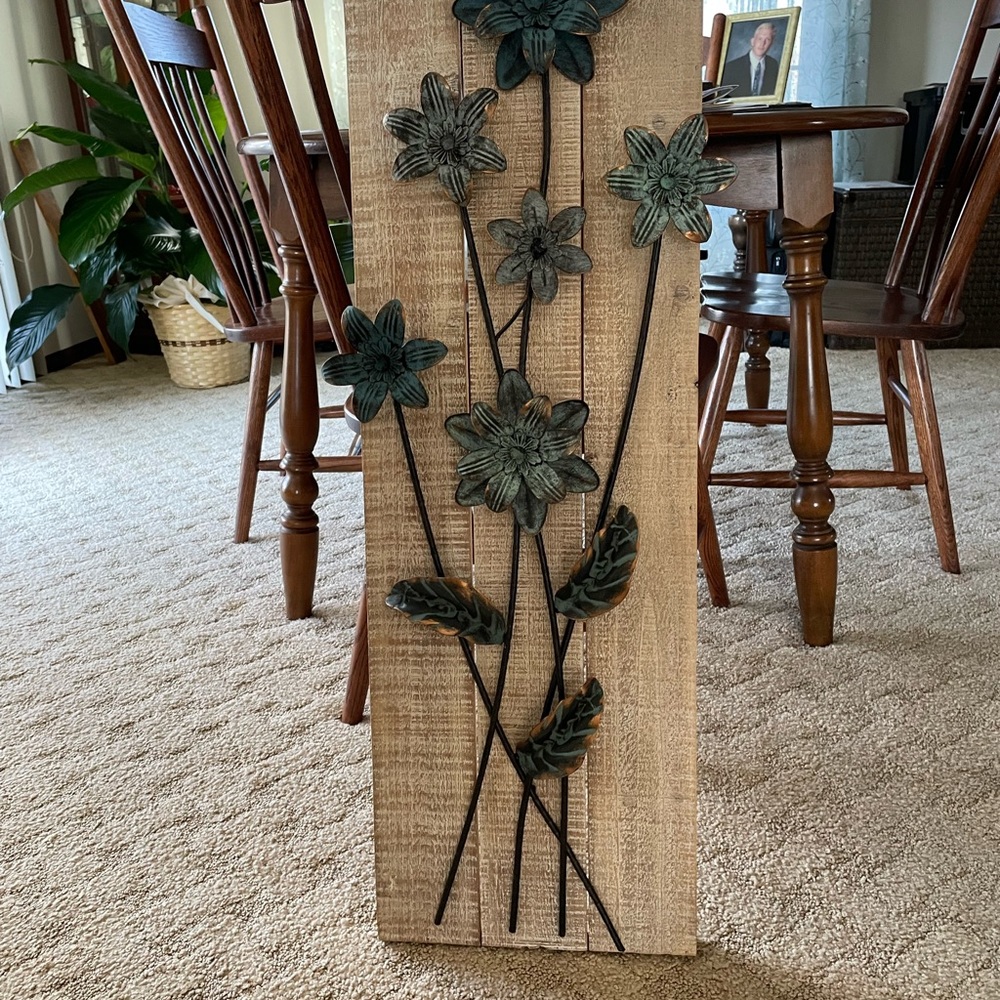 Metal blue and chrome flowers on wood.  New never used. Bought at Hobby Lobby.